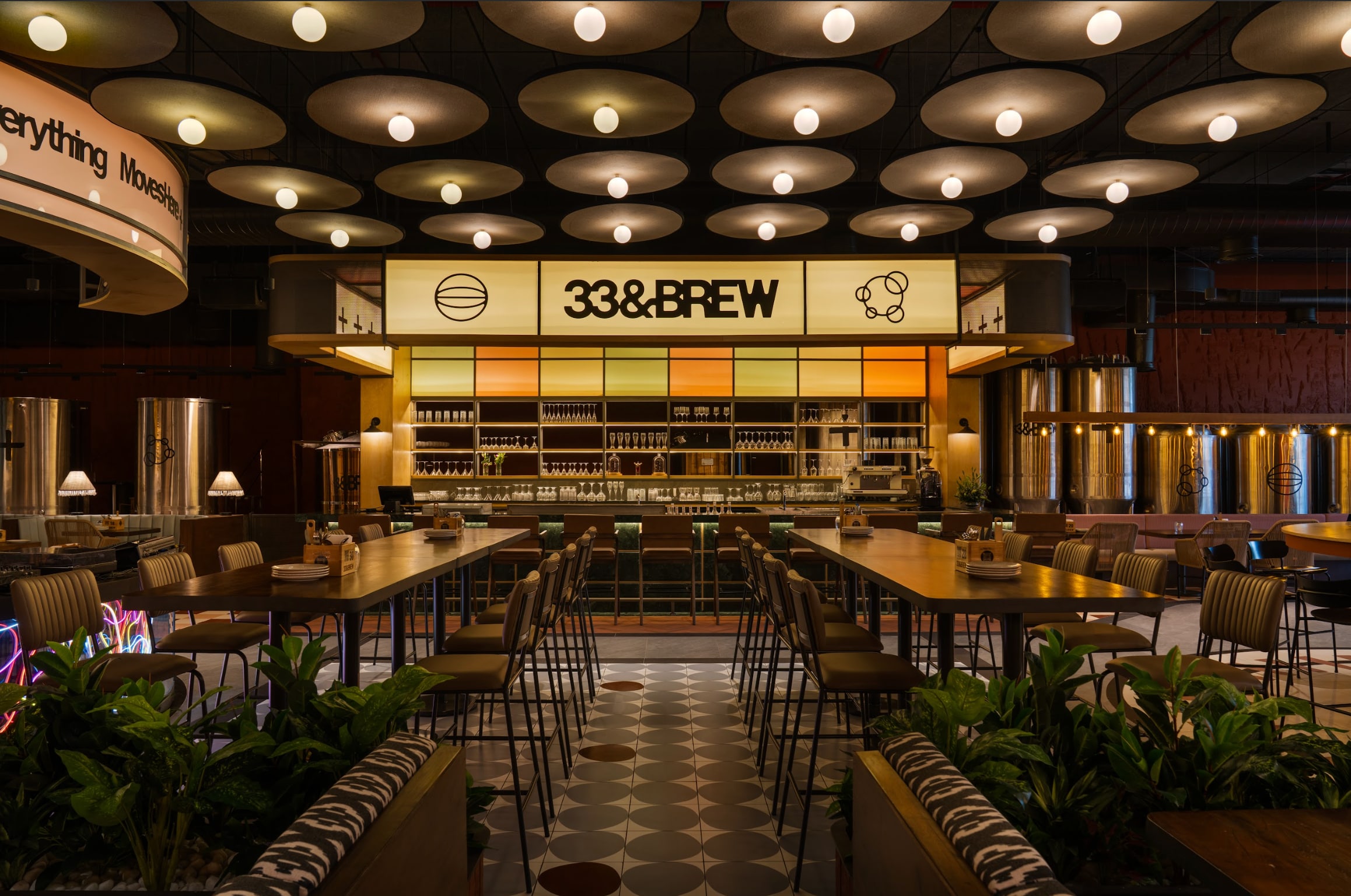 The 33&BREW taproom at Prestige Techno Star, Brookfield, with its disc-lit ceiling and brewing tanks